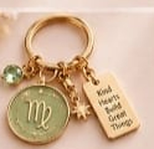 Virgo zodiac keychain with a gold ring, enamel sign disc, crystal, star charm and tag reading Kind Hearts Build Great Things
